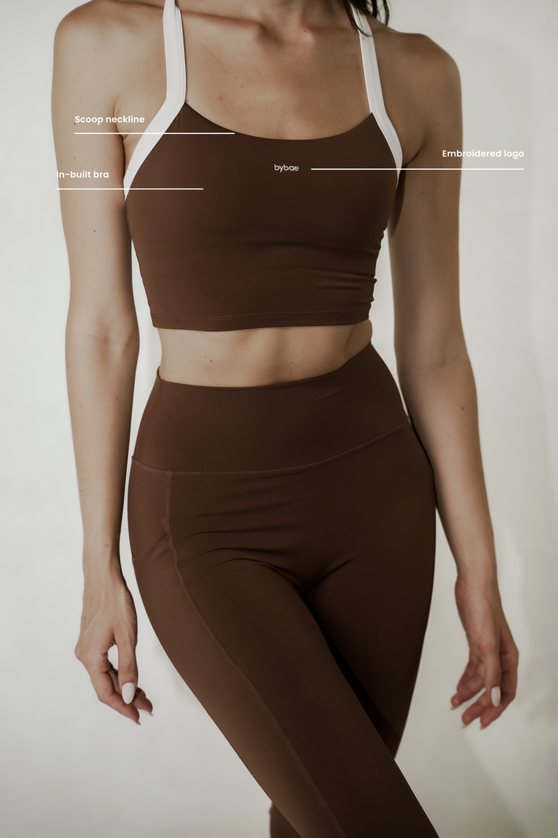 Model wearing buttery soft crop top with adjustable straps and in-built bra, showcasing a comfortable fit and versatile design for all-day support.