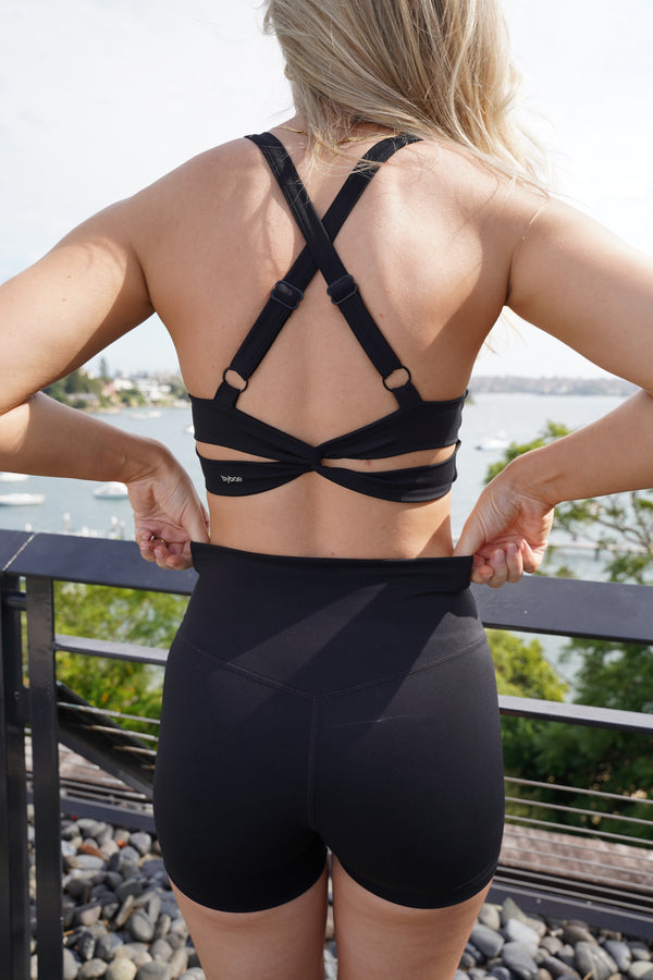 Model wearing Original Sports Bra with sculpting support and second-skin feel, crafted from 80% recycled nylon for a sustainable and comfortable fit during workouts.