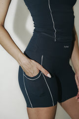 Model wearing Vintage Blue Original Shorts with lace trim and embroidered logo, showcasing a flattering fit and comfortable stretch fabric for active and casual wear.